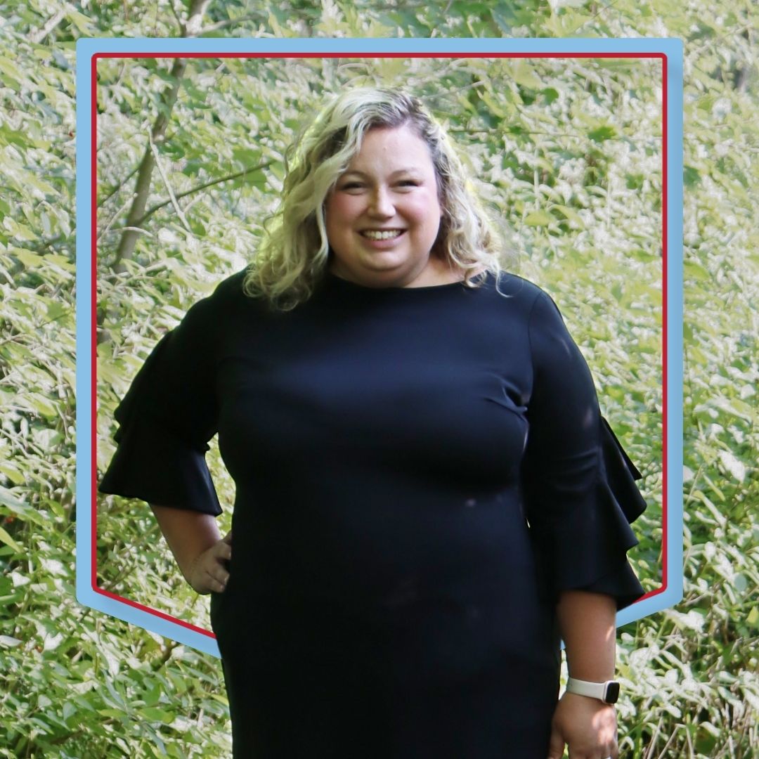 Alexis Grossman poses in front of a wooded background.